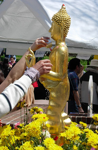 pouring water on the Buddha