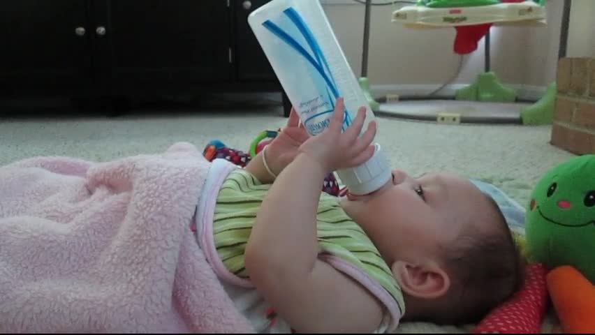 Holding her bottle at 4 ½ months